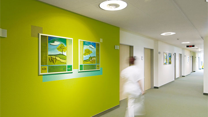 Una enfermera camina por un corredor iluminado por Philips en la clínica psiquiátrica